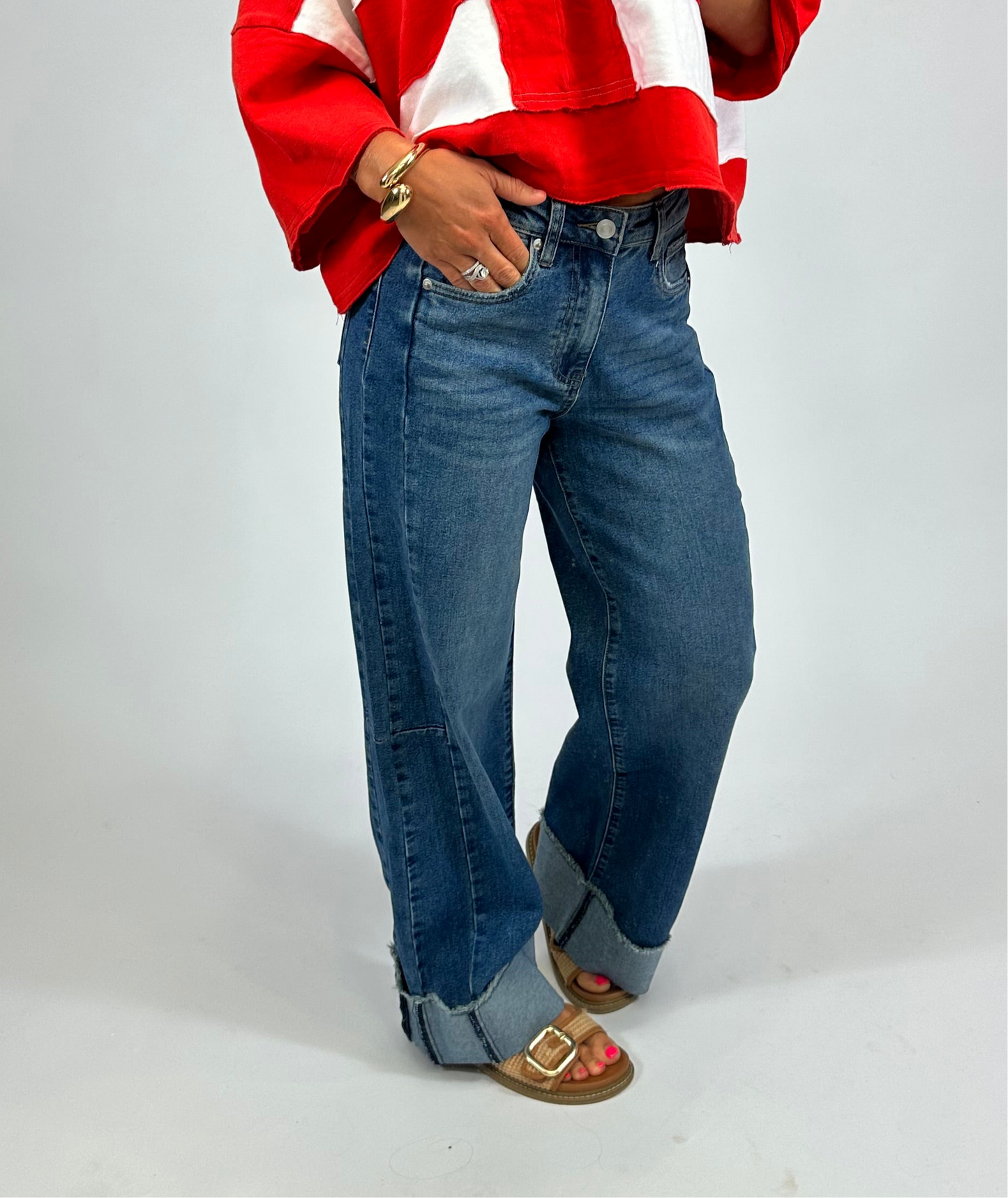 Model wearing Birdie Jeans in dark wash with rolled cuffs from August Moon Boutique