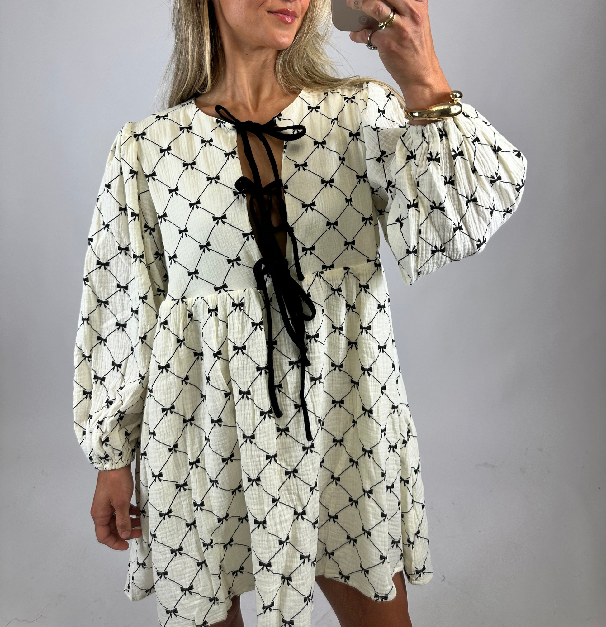 black and cream dress with ribbons on it for women